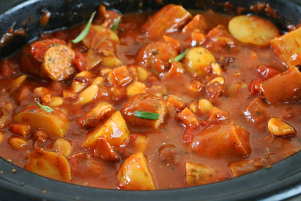 Stock photo showing elevated view of sausage, potato, carrots and bean casserole which has been slowly cooked in a flavoursome tomato sauce.