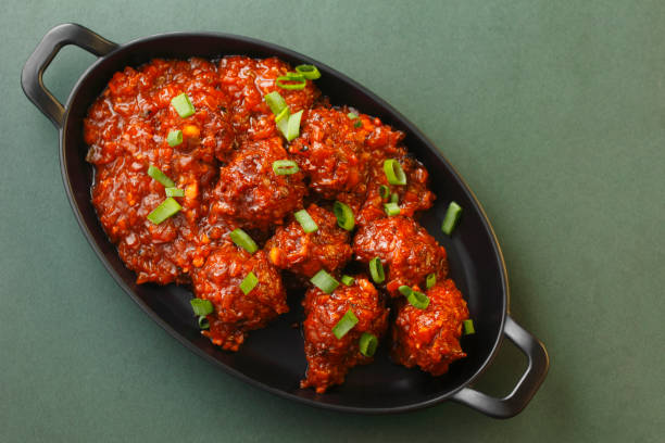 Cabbage Manchurian Served In Bowl On Table